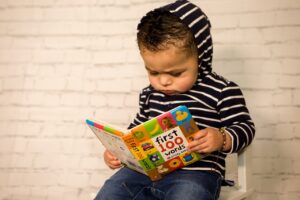 Toddler reading a book called First 100 Words