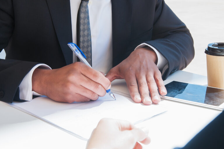 Businessman writing on a piece of paper