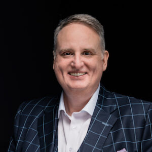 White man smiling at camera