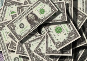 A stack of dollar bills in uneven piles
