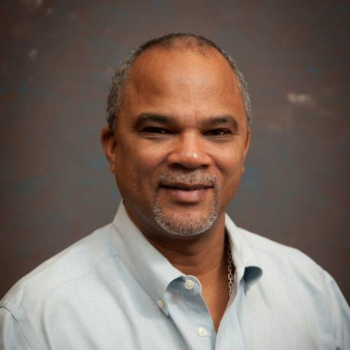 Hispanic man with goatee grinning at the camera
